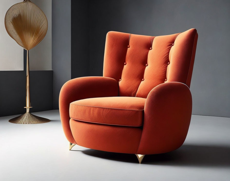 Luxurious Orange Armchair with Button Details and Gold Accents on Dark Grey Background