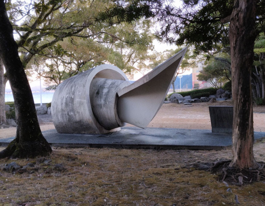 Spiral-shaped concrete sculpture in twilight park setting