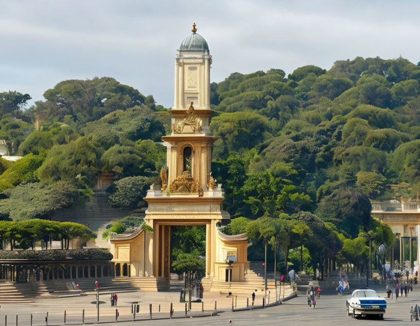 Neoclassical monument with tall tower and gold statues in green landscape