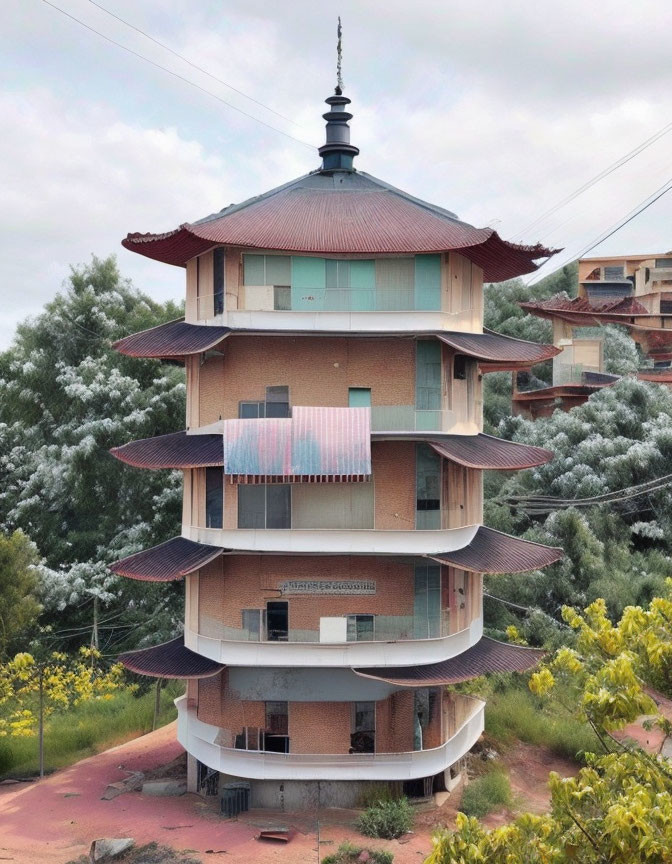 Brown-walled pagoda with red eaves and central spire in green surroundings