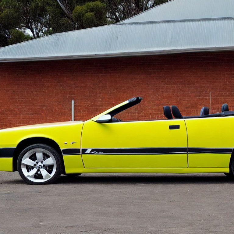 Yellow Convertible Car Parked in Front of Building with Red Roofs