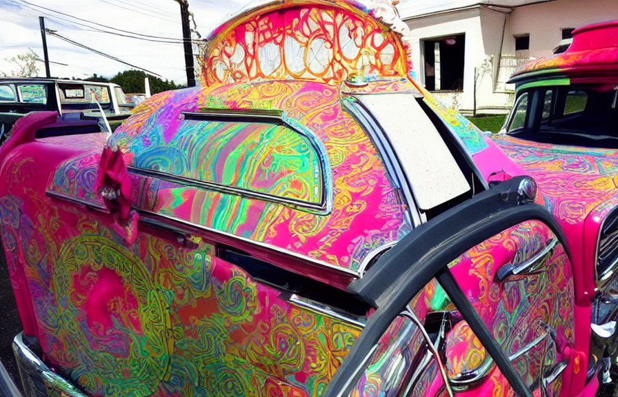 Colorful Psychedelic-Patterned Classic Car Under Bright Sky