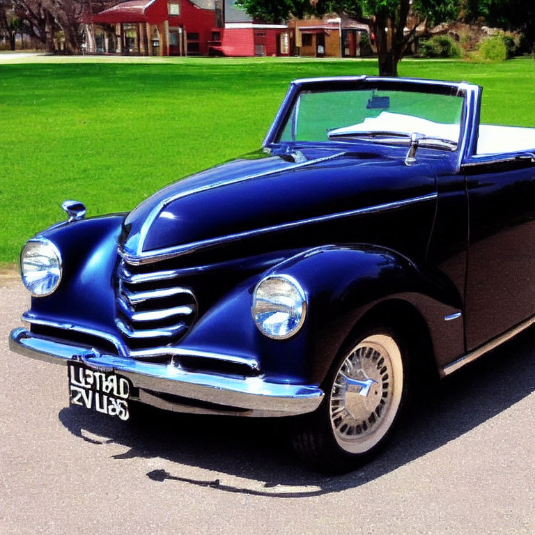 Vintage Blue Convertible Car Parked Near Grass and Buildings