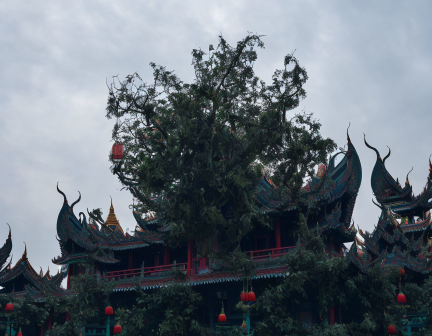 Ancient Chinese pagoda with red lanterns in tranquil setting