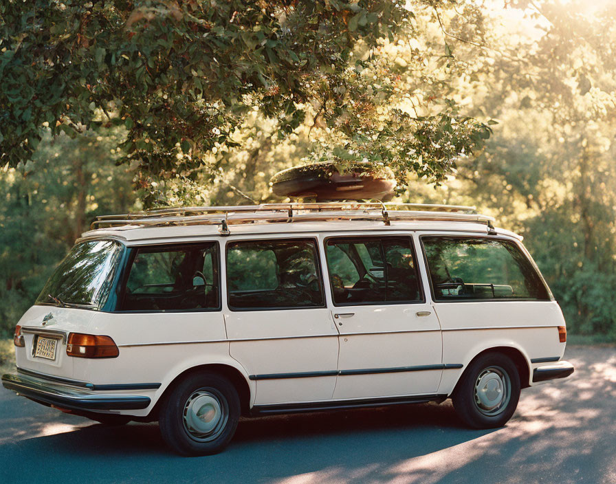 Classic White Van with Roof Rack Parked Under Sunlit Trees