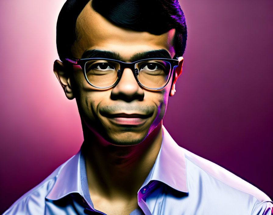 Young man with glasses in purple shirt on gradient background