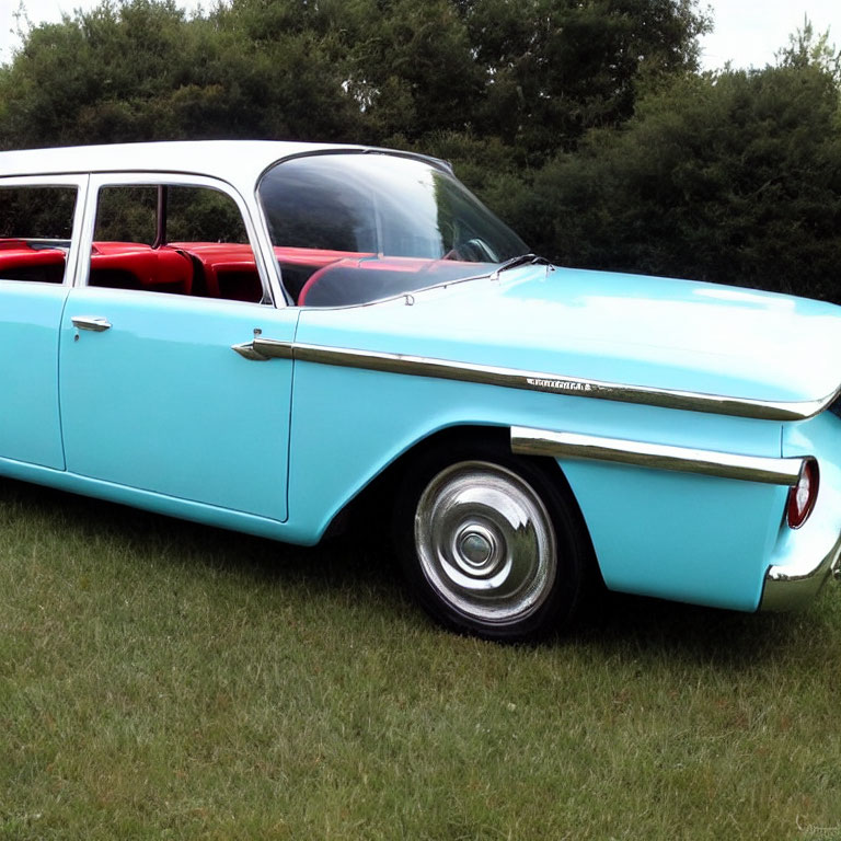 Vintage Turquoise and White Car with Red Interior and Chrome Detailing