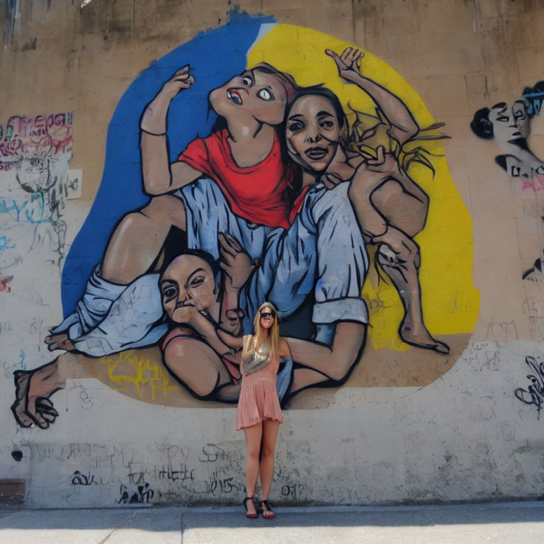 Colorful street mural featuring expressive characters and graffiti wall with yellow circle.