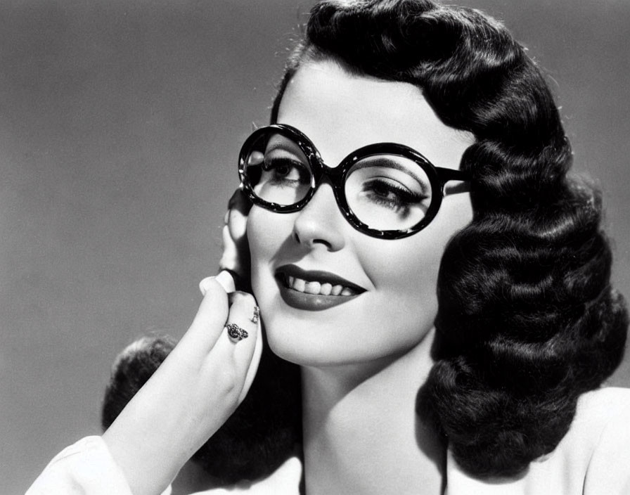 Monochrome portrait of woman with wavy hair and round glasses