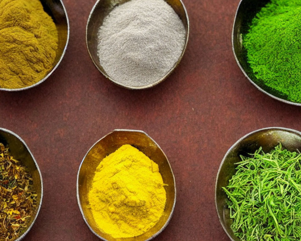 Six Colorful Spices and Herbs in Small Bowls on Dark Red Background