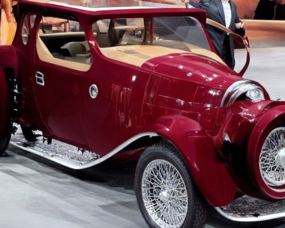 Vintage Red Car Displayed with Person in Suit at Event Background with Graphics