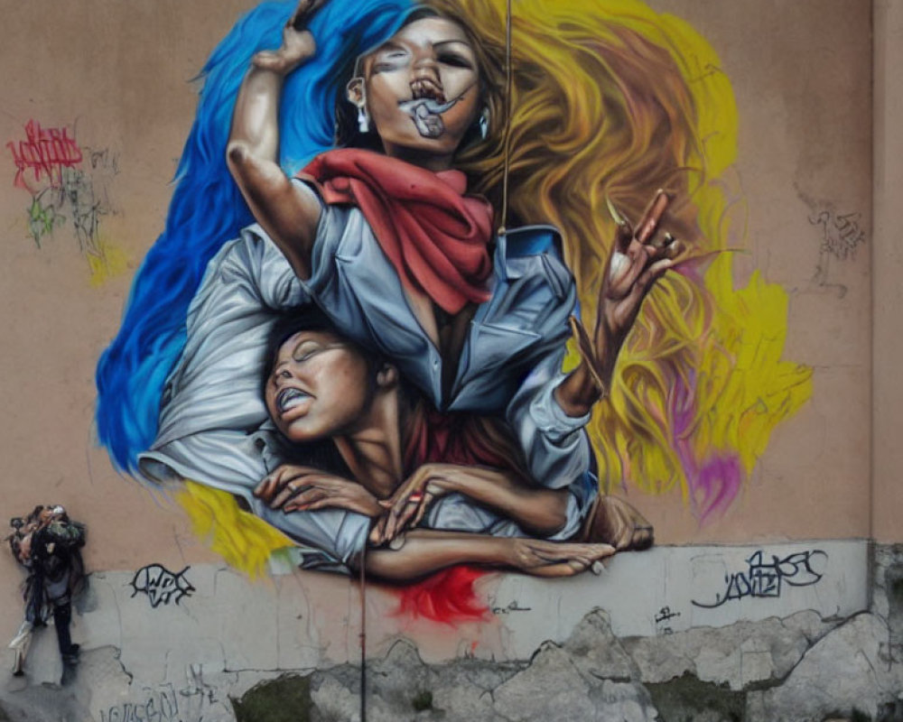 Colorful street art mural of two people with flowing hair on urban wall