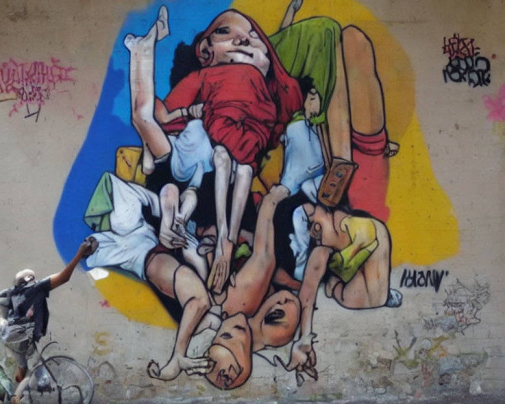 Colorful street art mural featuring giant baby dolls on blue and yellow background