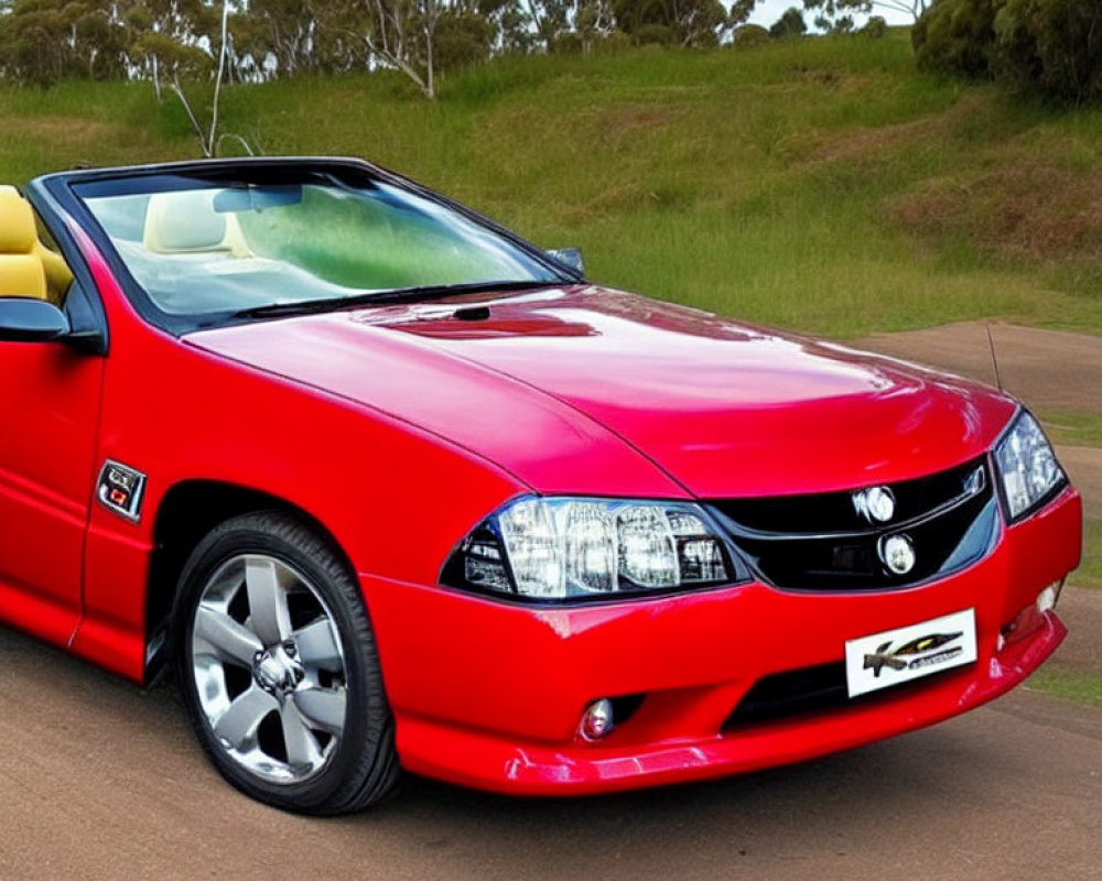 Convertible Sports Car Parked with Headlights On Near Roadside Greenery