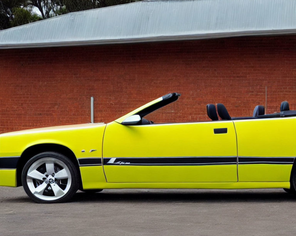 Yellow Convertible Car Parked in Front of Building with Red Roofs