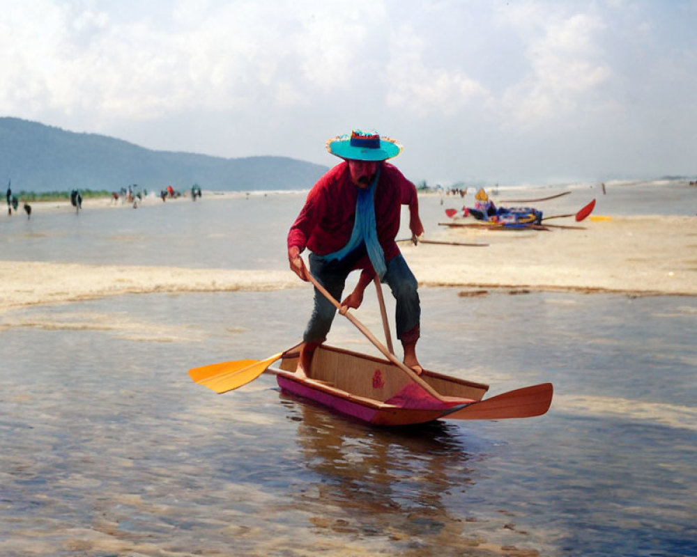 Person in red shirt paddling wooden boat near beach with people and boats.