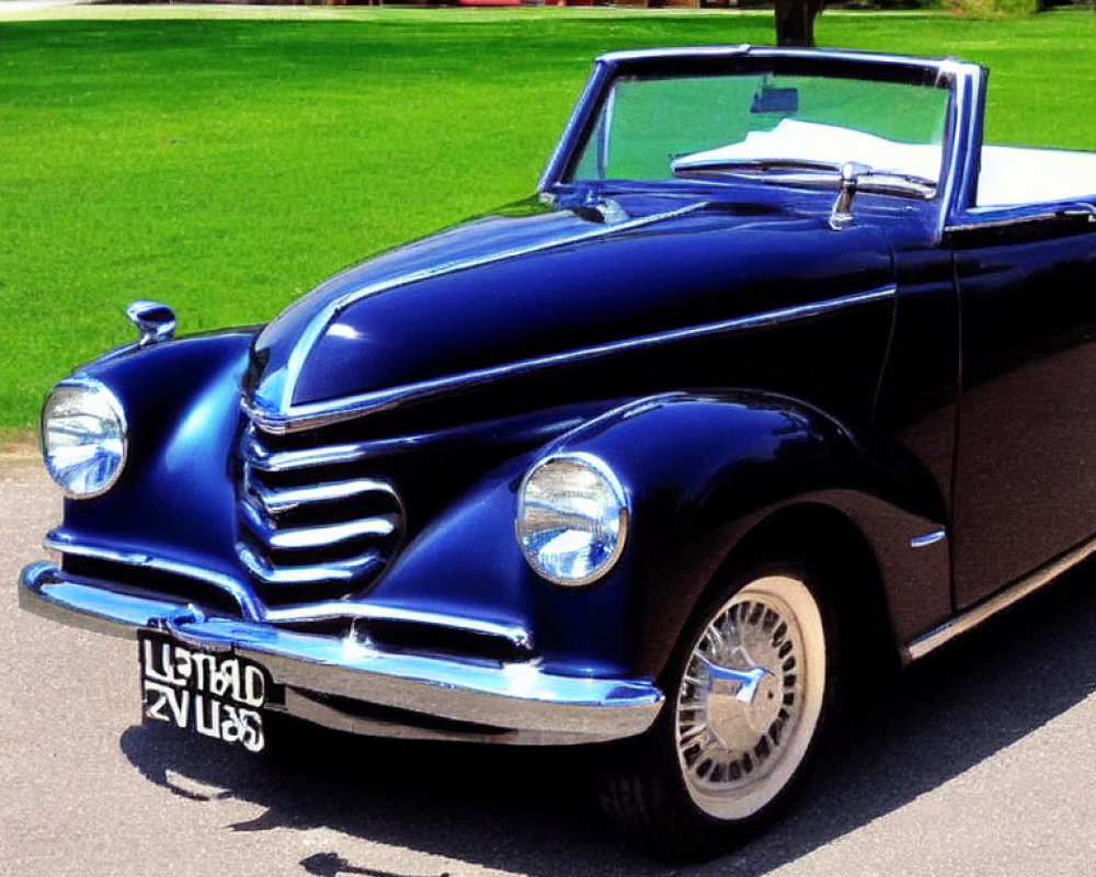 Vintage Blue Convertible Car Parked Near Grass and Buildings