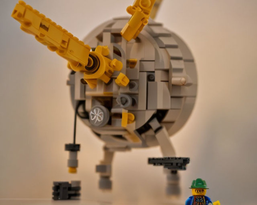 LEGO satellite model with dish antenna and astronaut figure