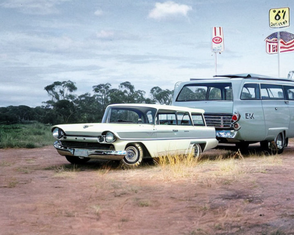 Vintage white and green station wagon and classic green van parked on dusty road with road signs and cloudy sky