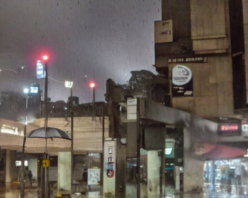 Rainy Evening Scene: Wet Streets, Red Traffic Lights, Silhouette at Bus Stop