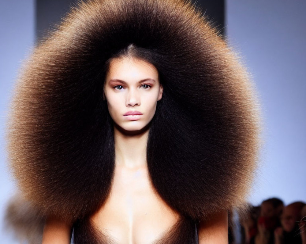 Exaggerated, voluminous hair model on fashion runway