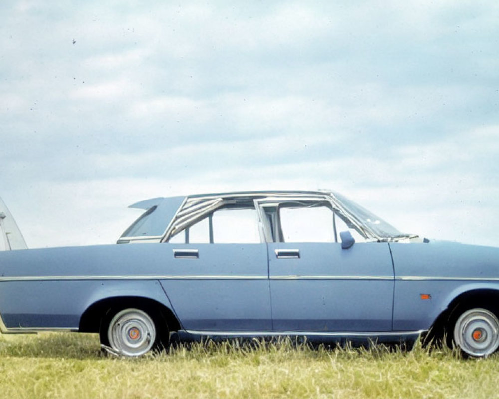 Vintage Blue Sedan Parked on Grass with Man Walking Towards Ladder under Cloudy Sky