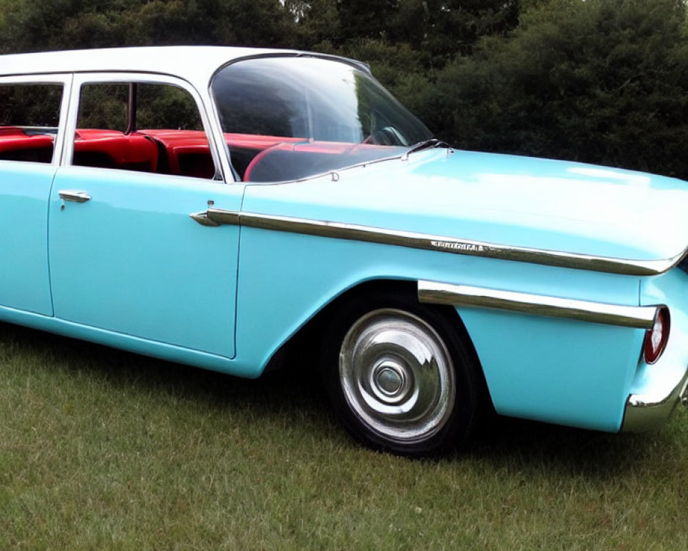 Vintage Turquoise and White Car with Red Interior and Chrome Detailing