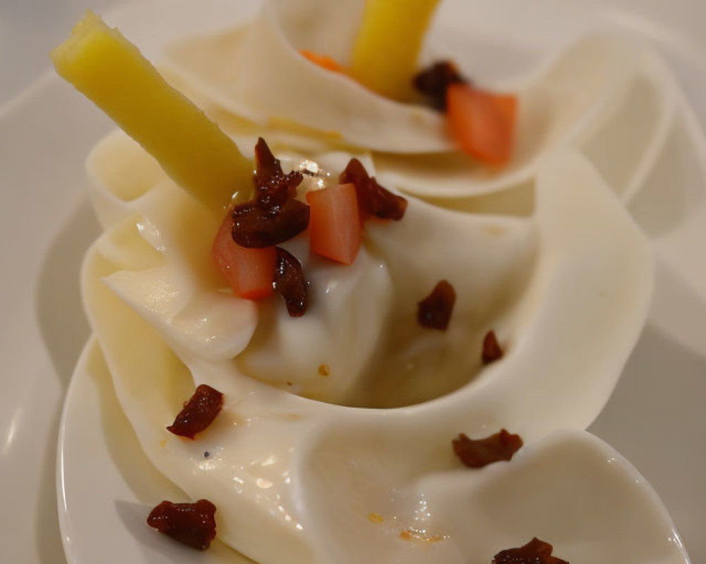 White Dumplings with Yellow Slices and Garnish on White Plate