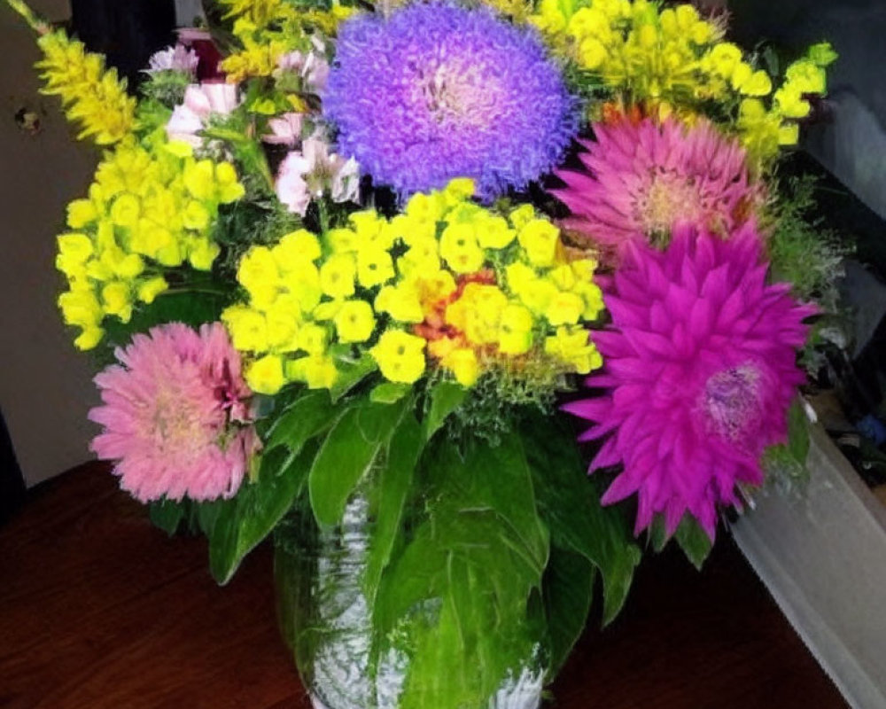 Colorful Pink, Purple, and Yellow Floral Arrangement in Glass Vase