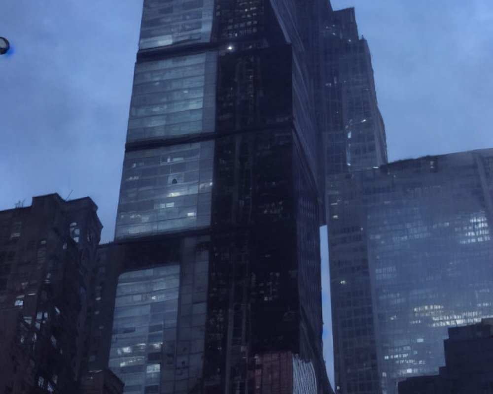 Modern skyscraper in urban cityscape at dusk