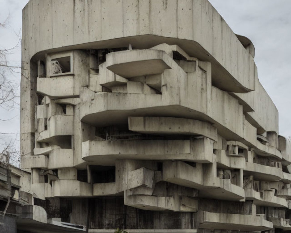 Staggered balconies on brutalist concrete building under overcast skies