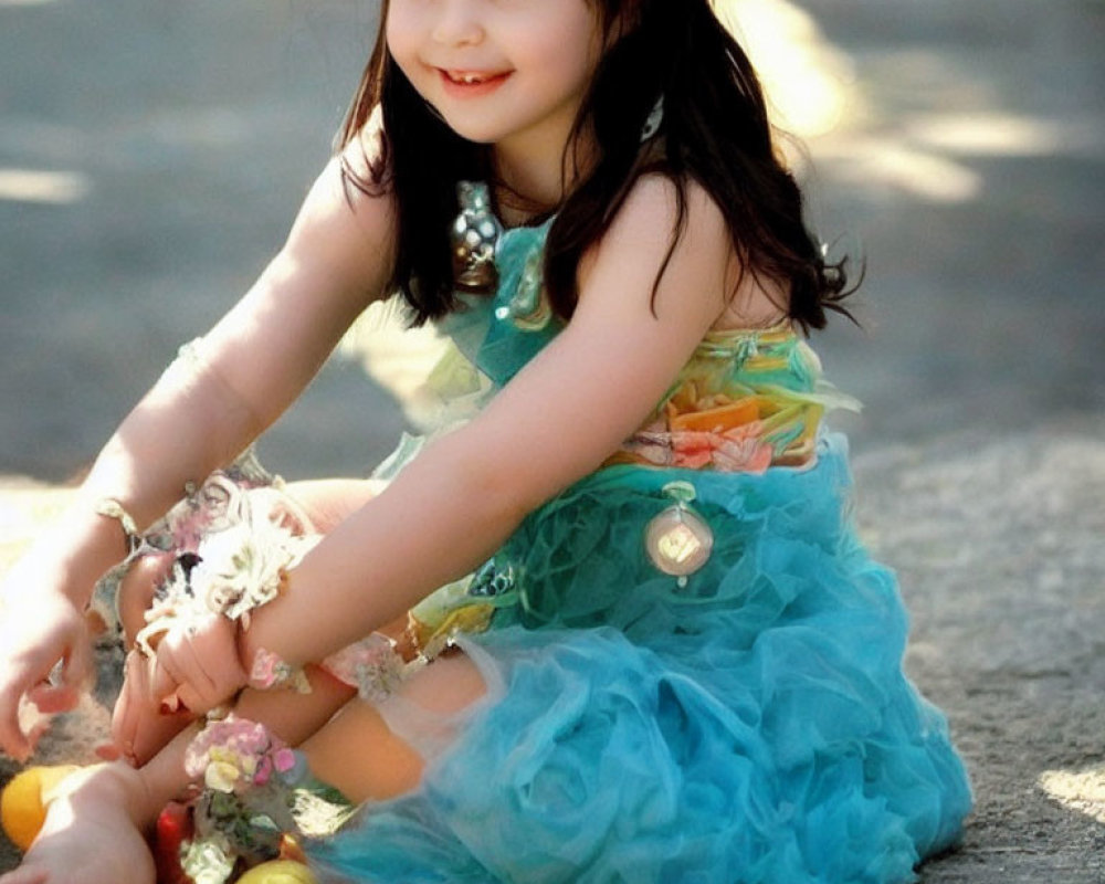 Young girl in blue tulle dress playing with Easter eggs