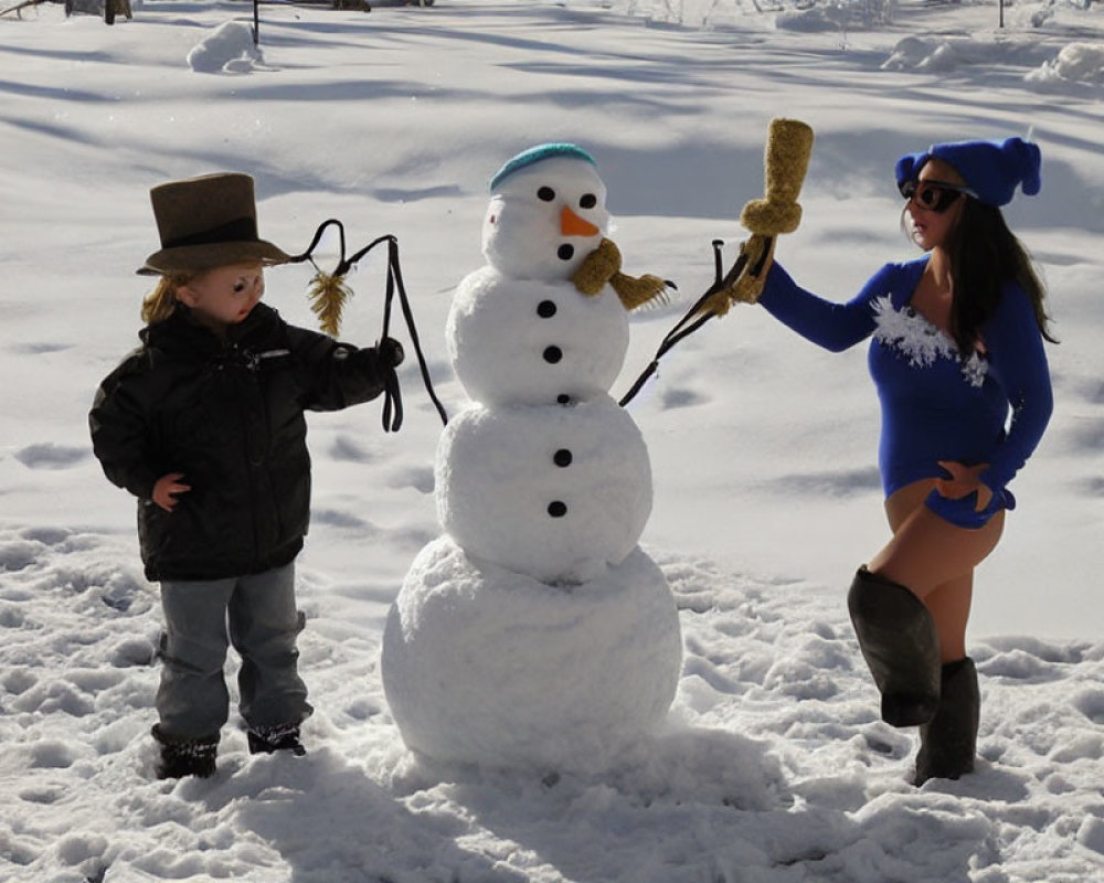 Child and woman by snowman in winter setting