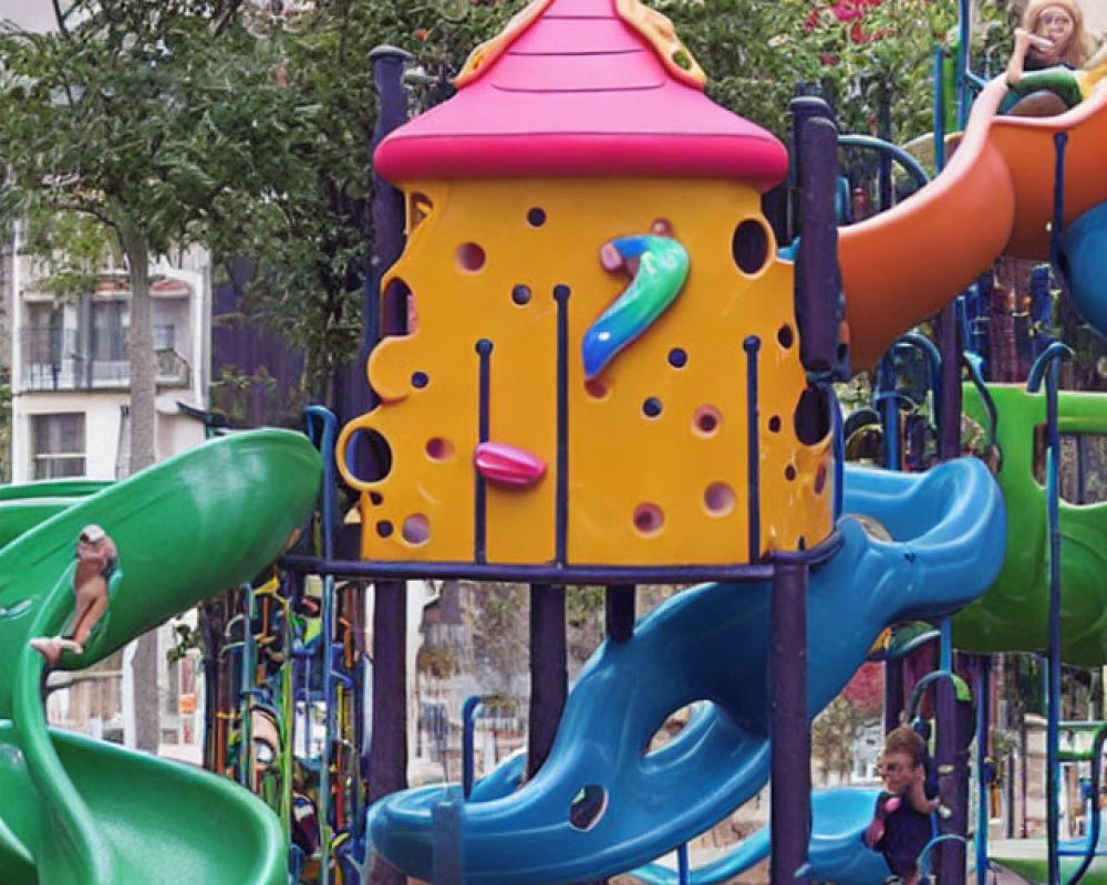 Vibrant yellow and purple playground with slides and climbing holes, green safety flooring, white fences,