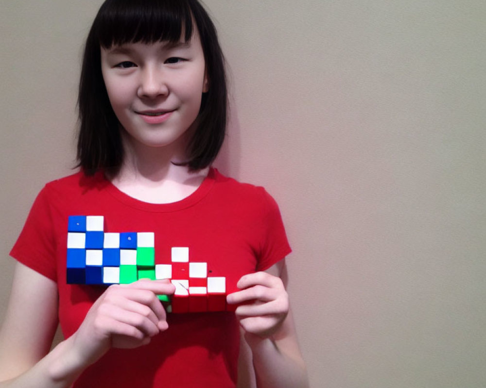 Smiling girl with bob haircut holding Tetris-themed puzzle