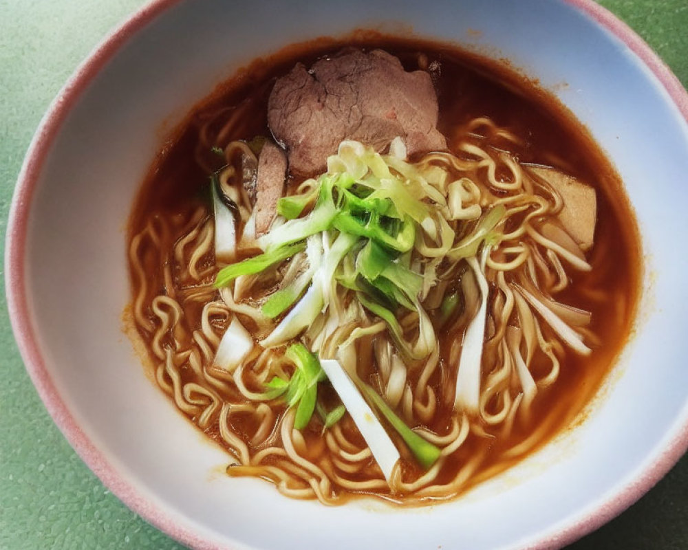 Savory ramen bowl with thin noodles, beef slices, scallions, and bamboo shoots