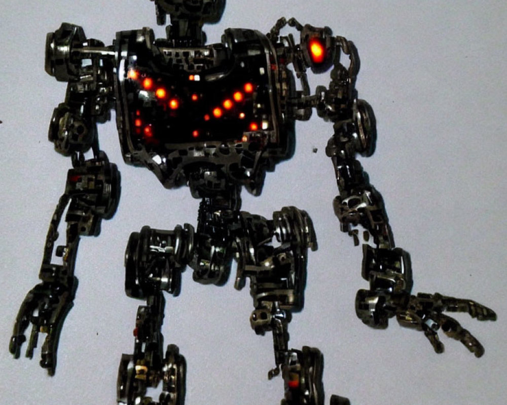 Articulated Metallic Robot Toy with Red LED Lights on Light Background