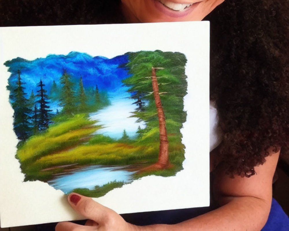 Smiling person holding vibrant landscape painting