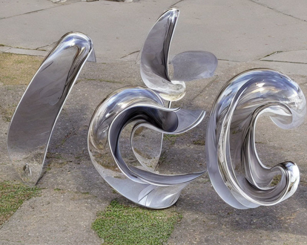 Abstract Swirling Metal Sculpture on Concrete with Grass Nearby