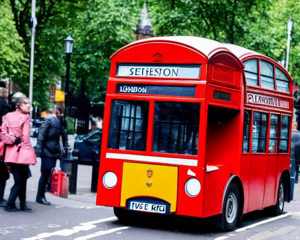 City street scene with red double-decker bus and pedestrians.