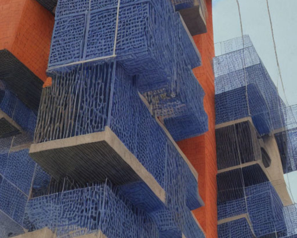 Modern Building with Orange Facade and Blue Mesh Balconies against Clear Sky