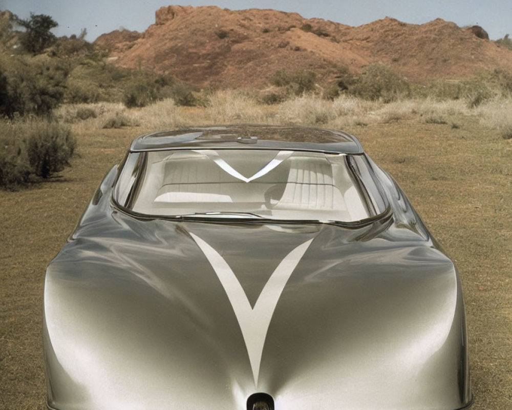 Sleek Silver Futuristic Car in Desert Landscape