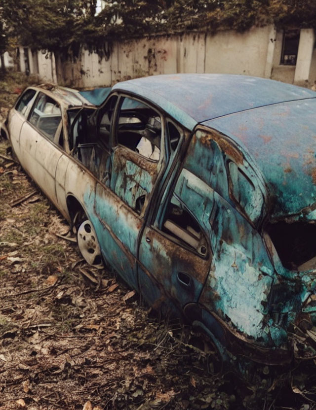 Abandoned Rusty Cars with Peeling Blue Paint in Neglected Setting