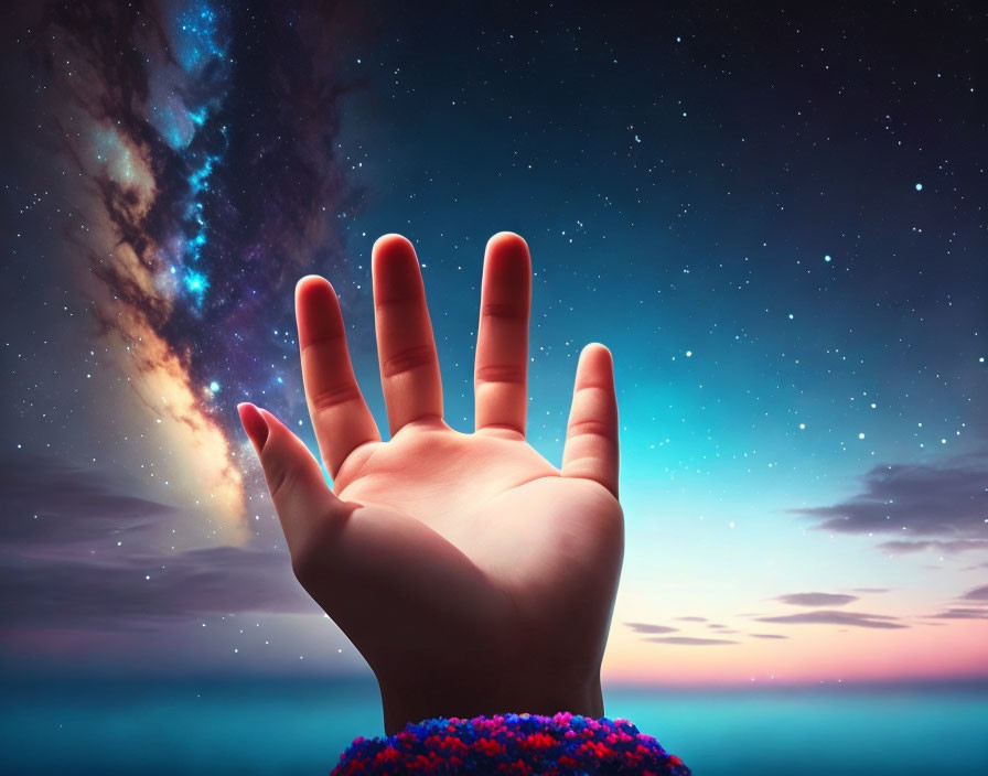 Hand reaching against vibrant twilight sky with stars and galaxy.