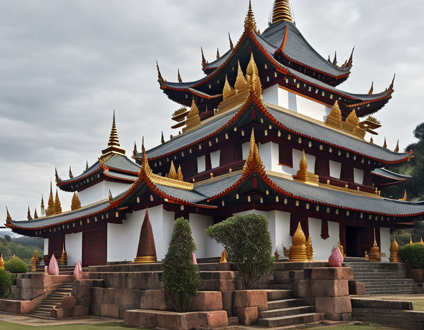 Asian temple with multi-tiered roofs and golden ornaments in a lush setting