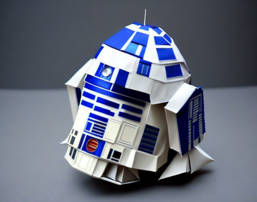 Intricate R2-D2 paper craft model with blue and white design