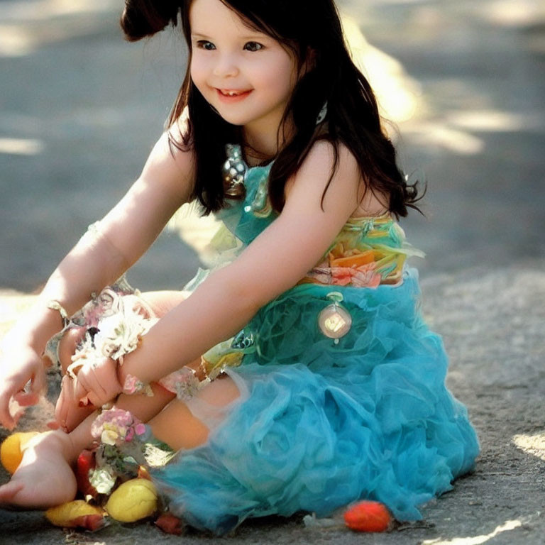 Young girl in blue tulle dress playing with Easter eggs