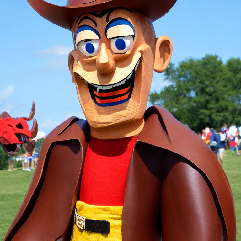 Person in Woody Toy Story costume with large head, cowboy hat, and red bandana outdoors