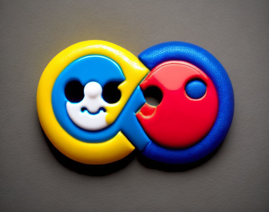 Cartoon-style magnets with happy and sad faces on grey background