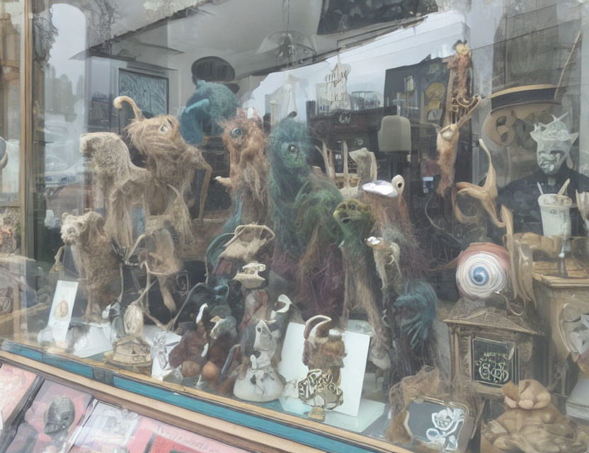 Whimsical felted fantasy creatures in bluish shop window display